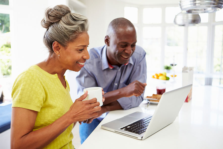 Older Black Couple Looking at Laptop Together